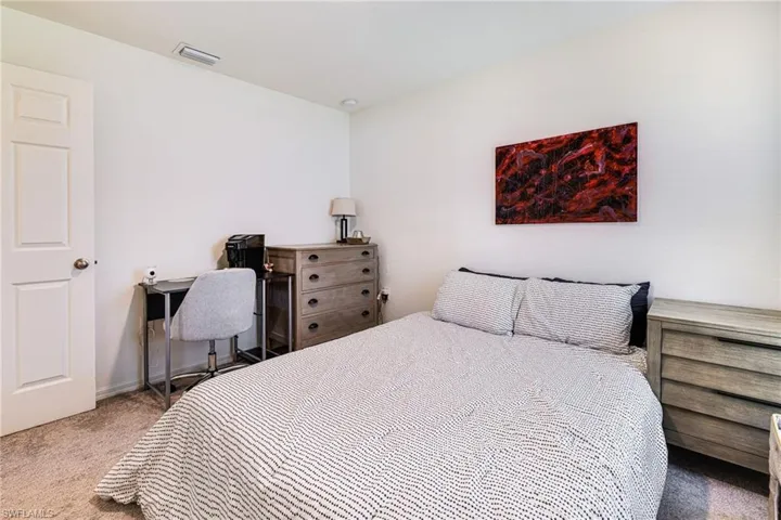 Guest bedroom - featuring baseboards and carpet floors