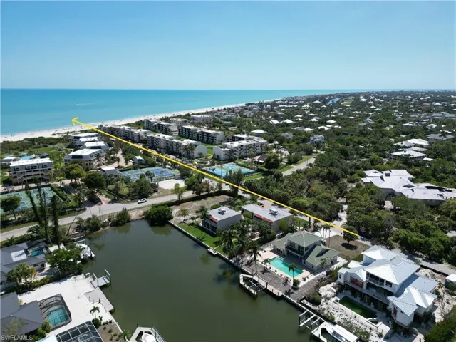Aerial perspective featuring a waterfront property with a private dock