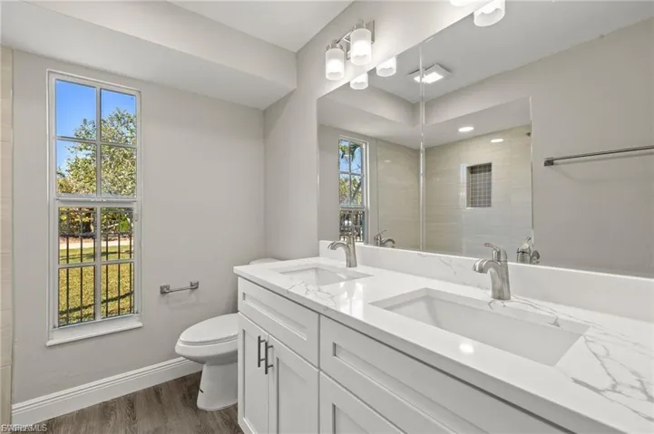 Dual vanity featuring integrated sinks and stone-finish countertops