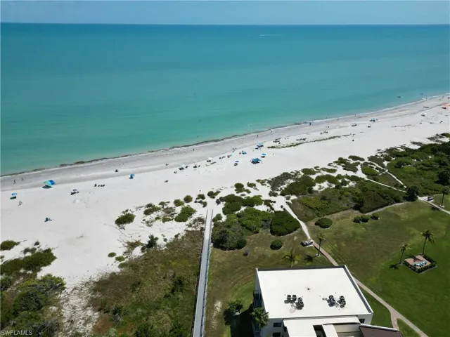 Expansive coastal frontage with white sand beach and turquoise water
