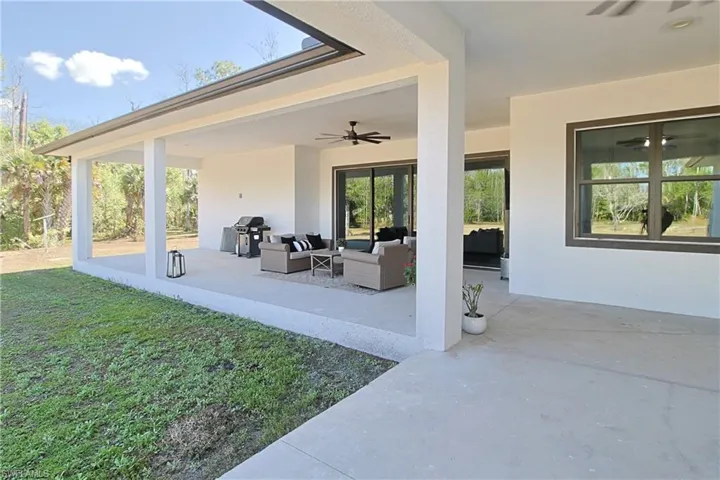 View of patio featuring outdoor seating, a ceiling fan, and a grill
