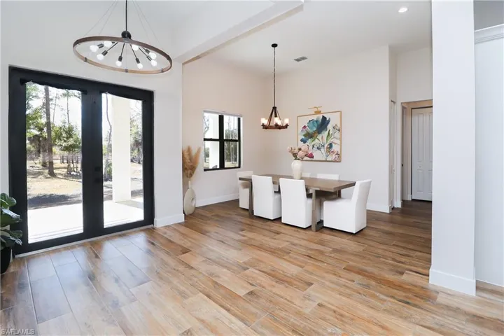 Unfurnished dining area featuring a chandelier and light wood-type flooring