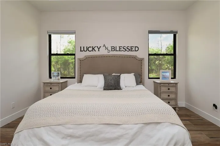 Bedroom with dark wood-style flooring