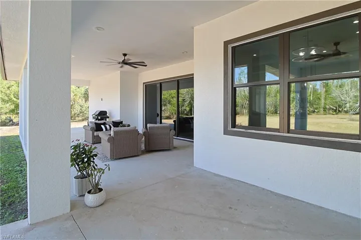 View of patio with ceiling fan and outdoor furniture