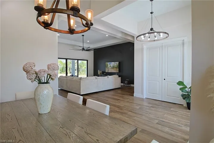 Dining area featuring suspended lighting, light wood-style flooring, and ceiling fan