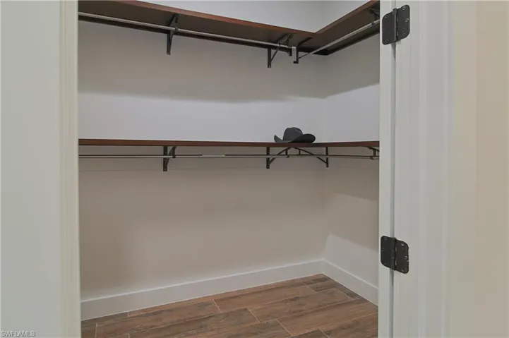 Walk in closet featuring wood tiled floors