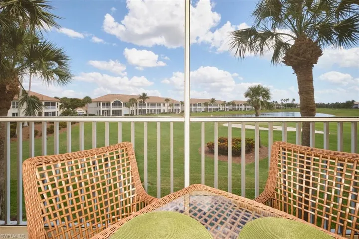Balcony with a residential view and a water view