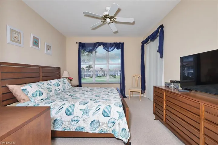 Bedroom with light colored carpet and ceiling fan