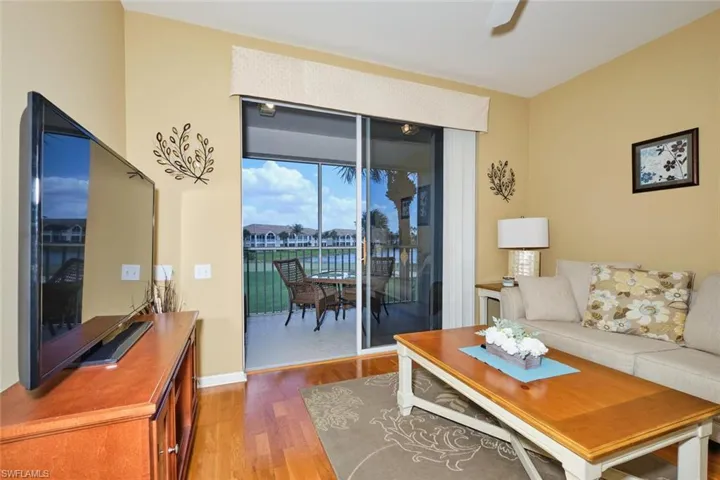 Living room with baseboards, ceiling fan, and wood finished floors