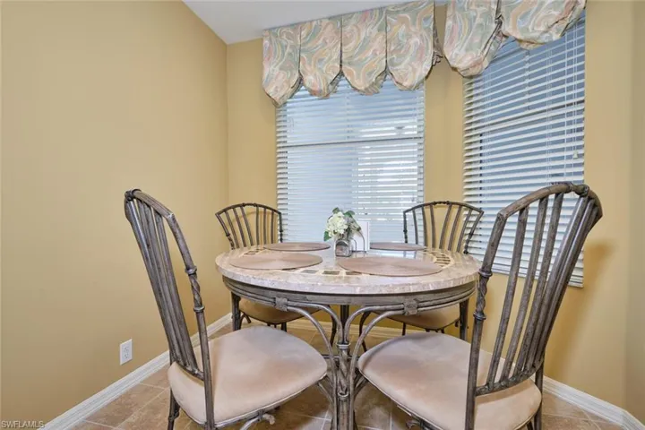 Tiled dining area featuring baseboards