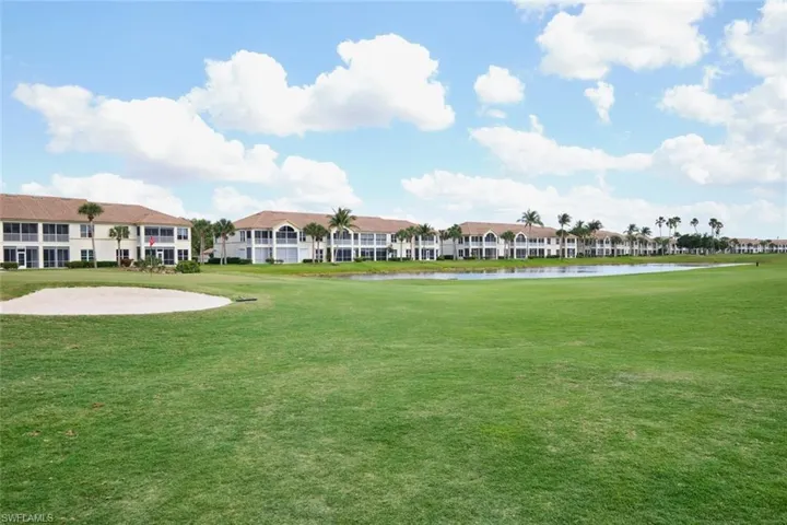 View of community with a water view and a yard