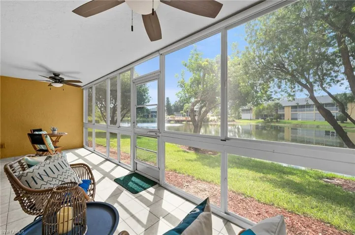 Expansive glass-enclosed screened lanai with lake & water feature views.