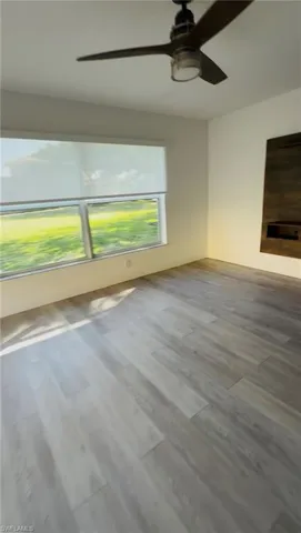 Full bathroom featuring double vanity, a shower stall, and light wood-style floors