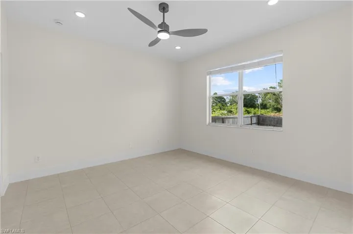 Unfurnished room featuring baseboards, ceiling fan, and recessed lighting