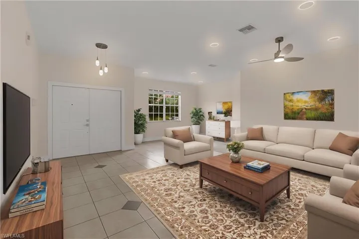 Living area with ceiling fan, visible vents, light tile patterned floors, baseboards, and recessed lighting