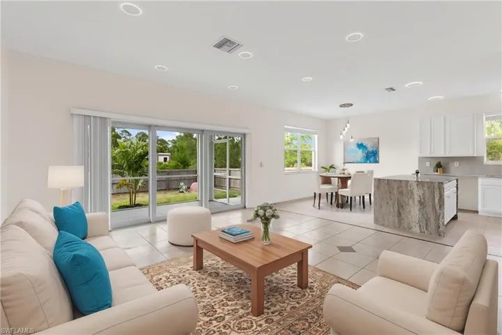 Living room featuring visible vents, recessed lighting, light tile patterned flooring, and a healthy amount of sunlight