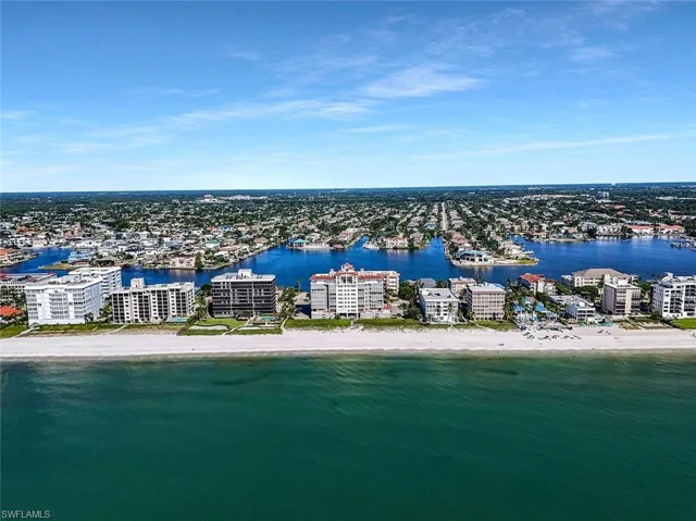 Coastal aerial perspective featuring direct oceanfront access, sandy shoreline, and proximity to expansive inland waterways