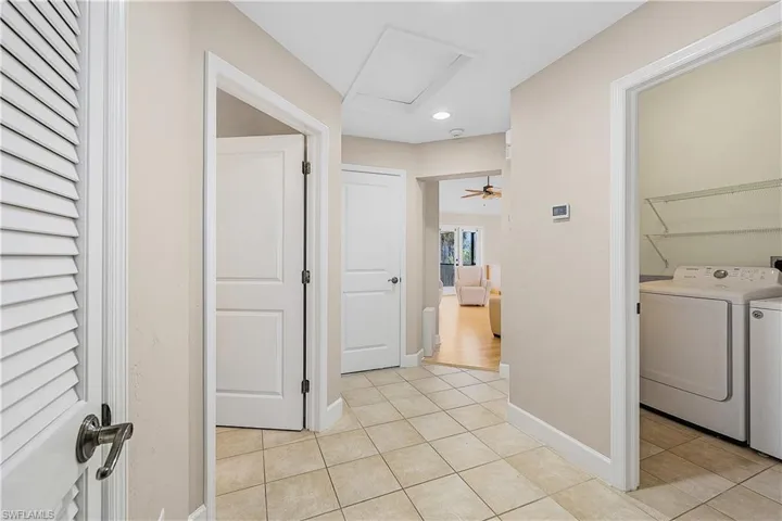 Hallway featuring tile floors
