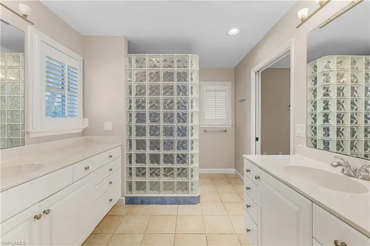 Bathroom featuring tile patterned floors and dual vanities