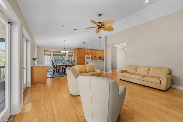 Living room with ceiling fan and wood-style flooring