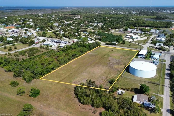 Expansive cleared land parcel outlined in yellow