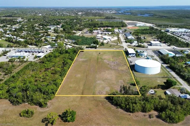 Expansive cleared lot outlined in yellow, featuring direct road frontage and a flat topography