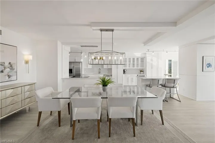 Dining area featuring light wood finished floors and track lighting