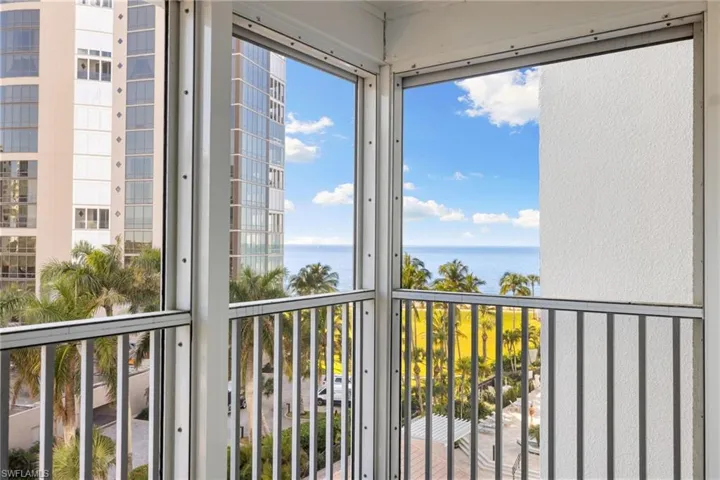 Balcony with a sunroom and a water view