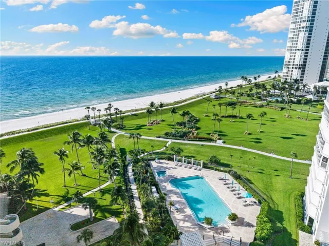 Drone / aerial view of extended coastline and a pool
