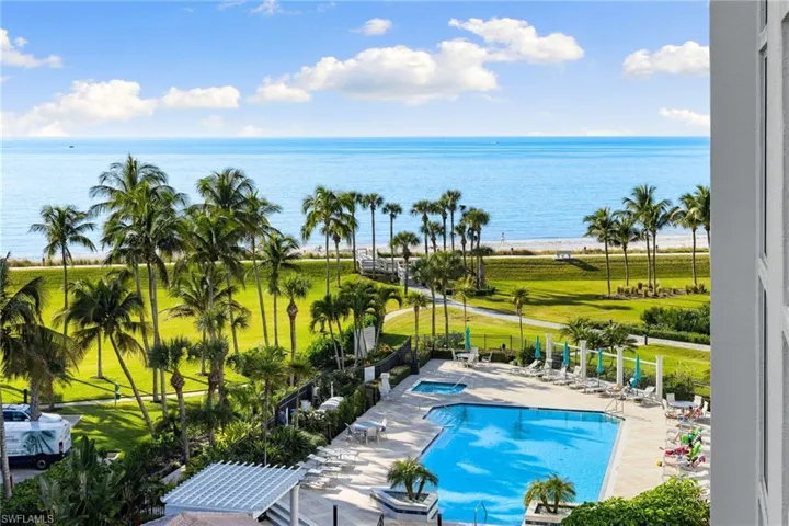 Community pool with a patio area and a water view
