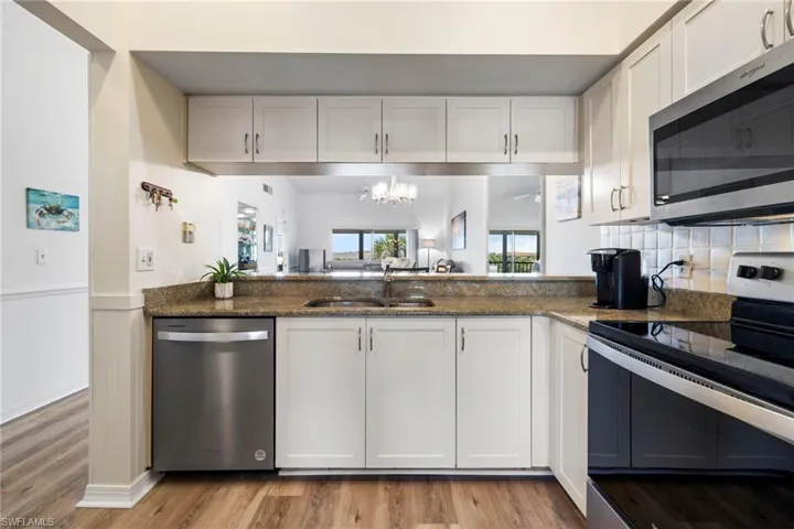 Kitchen with appliances with stainless steel finishes and white cabinets