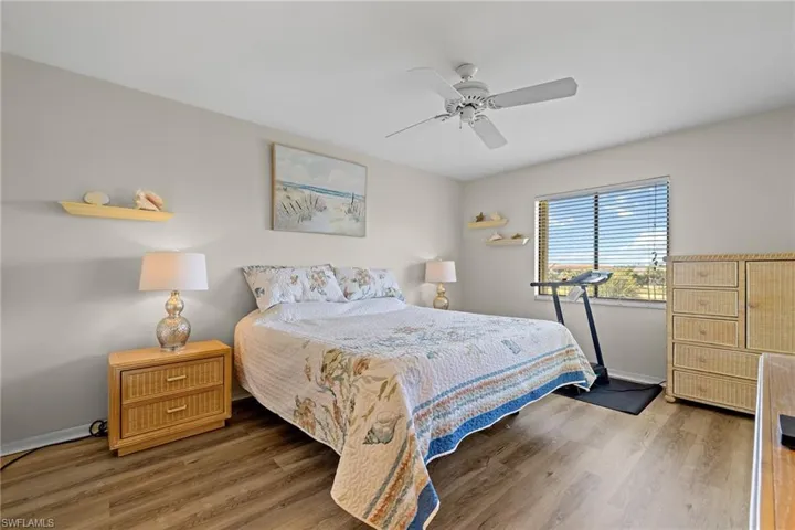 Bedroom featuring ceiling fan and dark hardwood / wood-style flooring