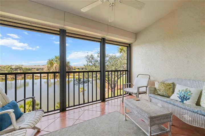 Sunroom with a water view and ceiling fan