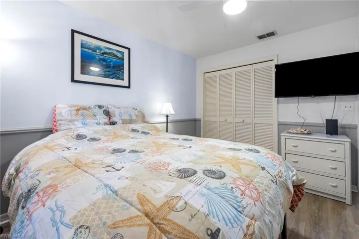 Bedroom featuring wood-type flooring, a closet, and ceiling fan