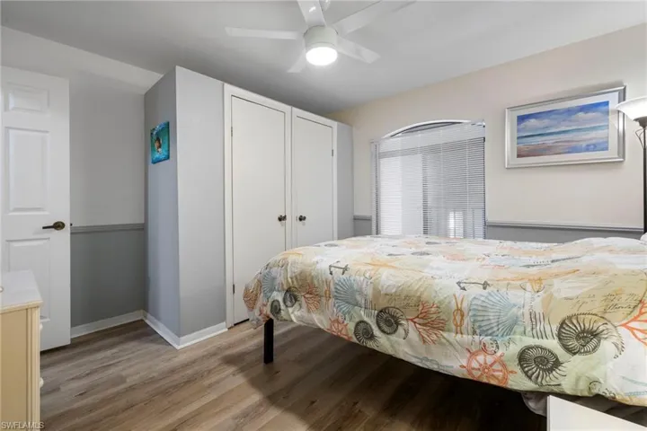 Bedroom with light hardwood / wood-style flooring, a closet, and ceiling fan