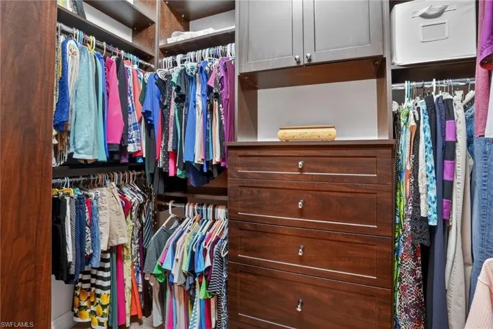View of spacious custom closet in the primary bedroom