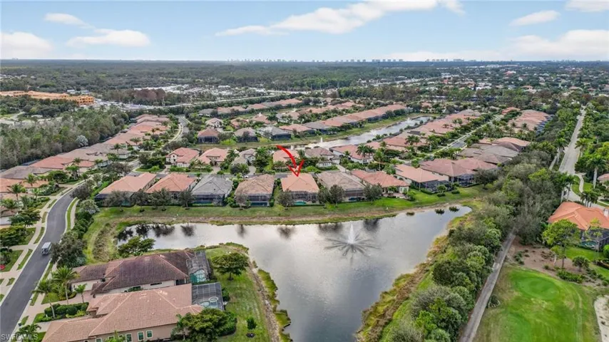 Aerial view of lake and property's location with nearby suburban area and a nearby body of water