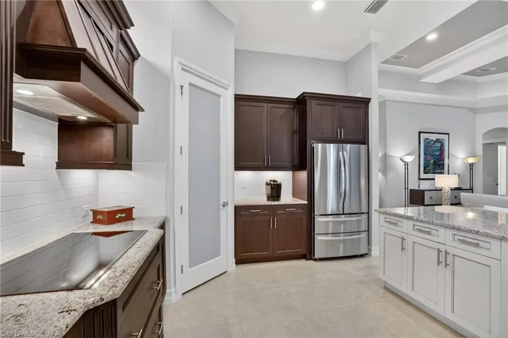 Featuring electric cooktop, pantry, and newer stainless steel refrigerator