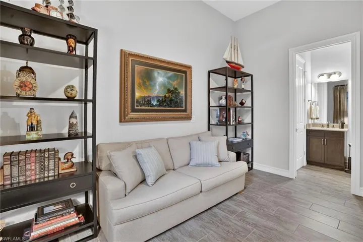 View of full bathroom from the den. The den/study can easily convert to a 4th bedroom with a wood like plank flooring