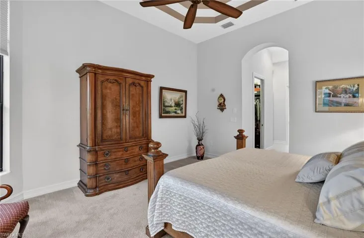 Featuring a spacious custom walk-in his and hers closet, tray ceiling with crown moulding