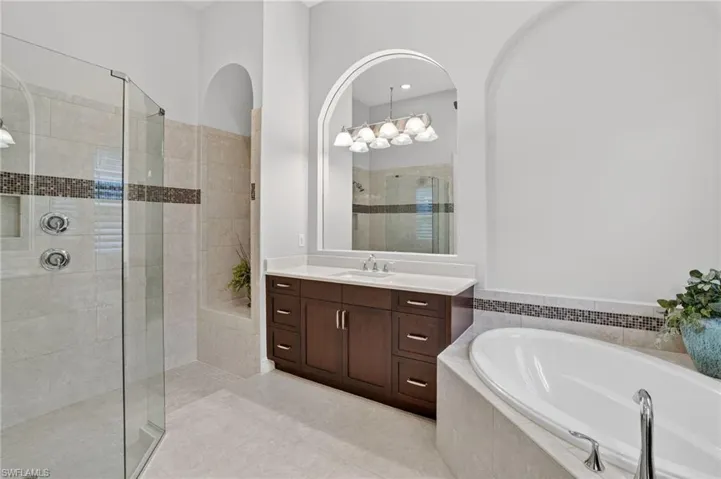 Spa-like bath, frameless glass shower doors, rain shower, soaking tub, with porcelain tiled floor