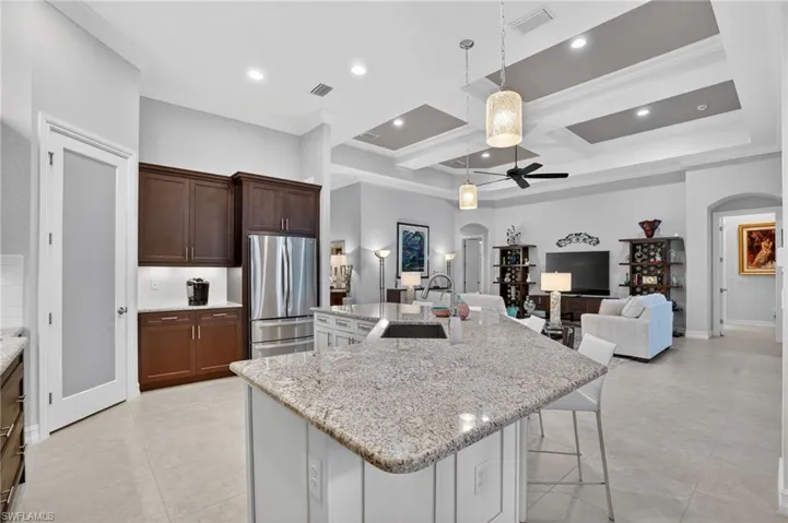 Featuring an island breakfast bar with open view of family room and entrance into the master suite