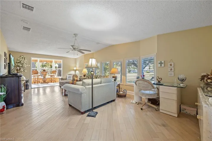 Living room from the front door with views of the Florida Room and backyard