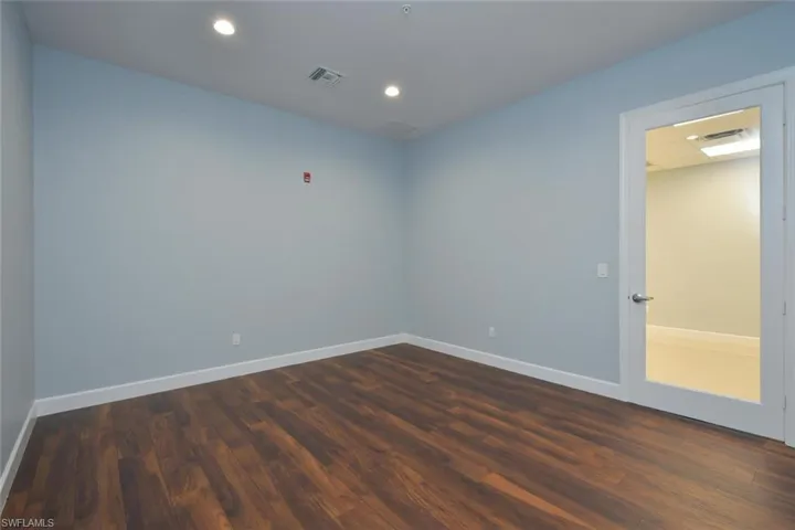 Unfurnished room with dark hardwood / wood-style flooring