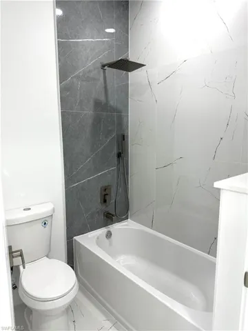 Bathroom featuring shower / washtub combination and vanity
