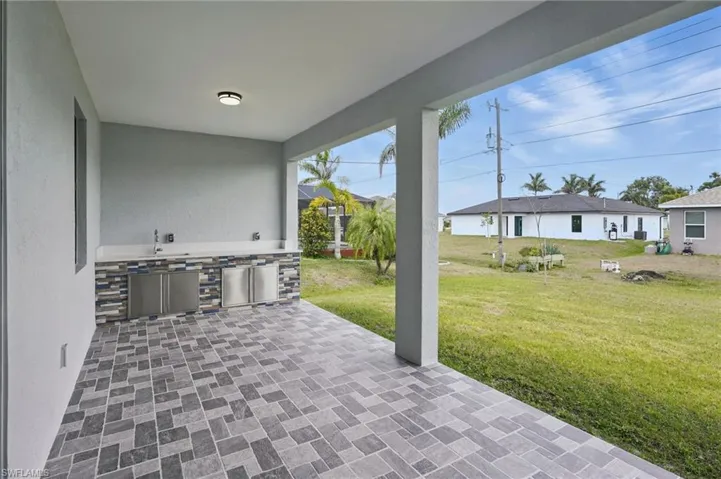 View of patio featuring area for grilling and a sink