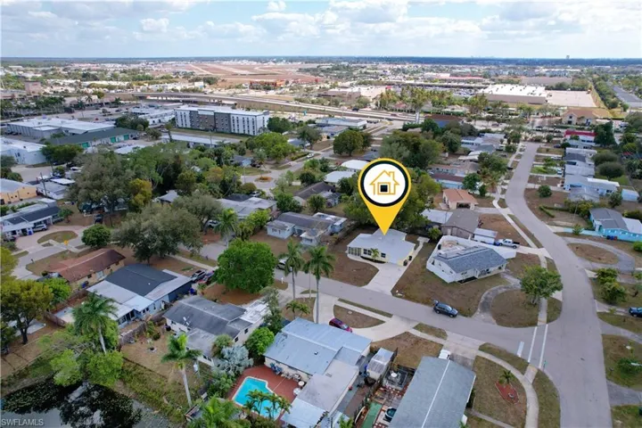 Aerial view of property's location featuring nearby suburban area