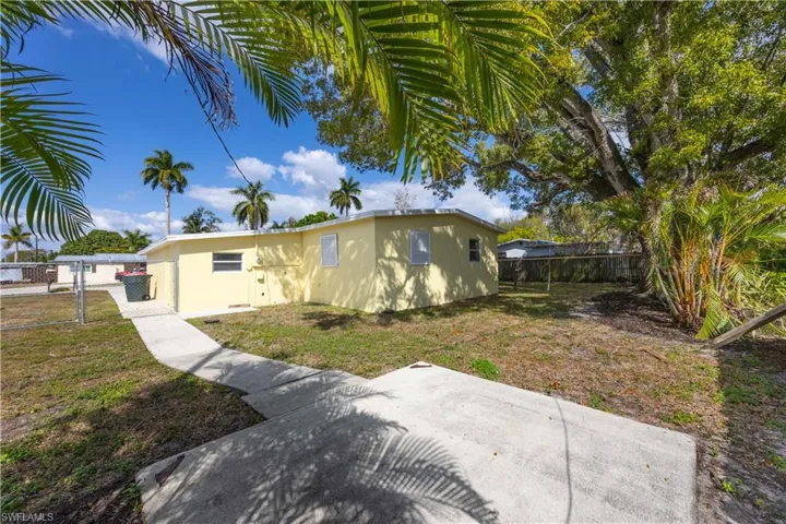 Back of property featuring a fenced backyard, a gate, and stucco siding