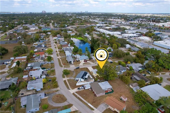 Aerial view of property's location featuring nearby suburban area and a large body of water