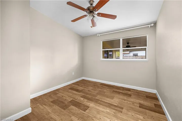 Empty room featuring light wood finished floors and a ceiling fan